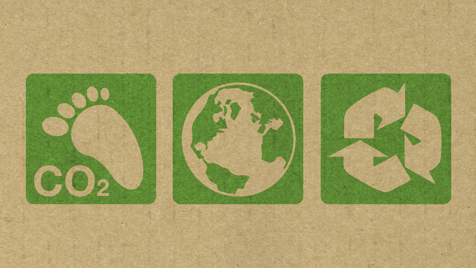 Green environment symbols stamped onto the side of recycled cardboard.