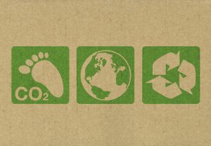 Green environment symbols stamped onto the side of recycled cardboard.